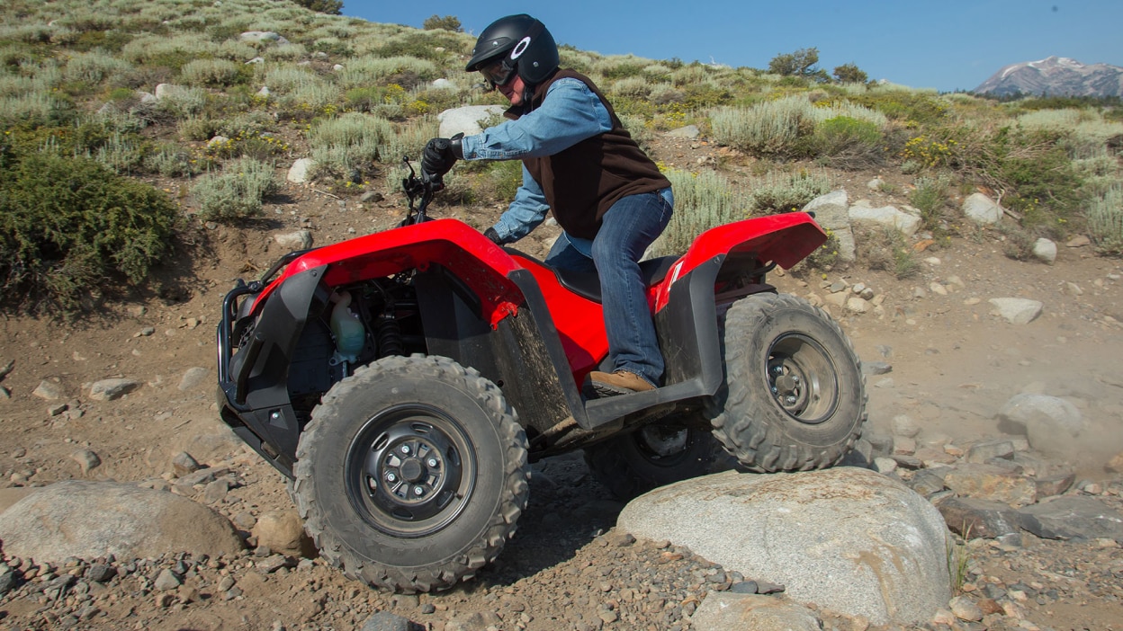 A rider going over a rock on a Rancher