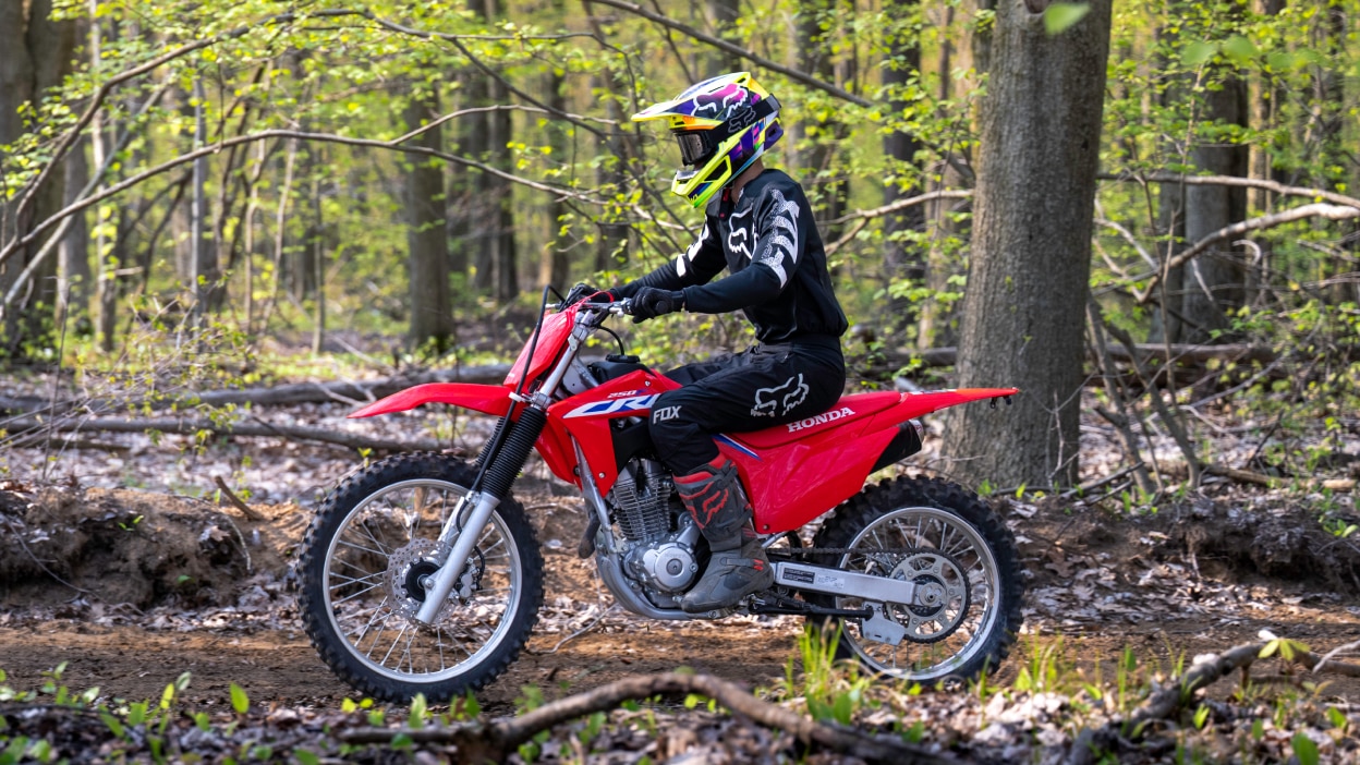 A young rider on a Honda CRF50F