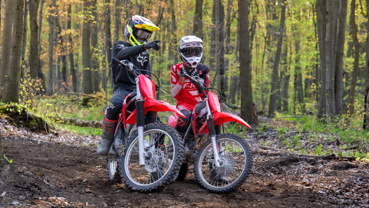 Two riders having a conversation pulled over on a trail 