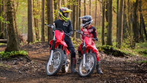 Two riders parked with their Honda CRFs