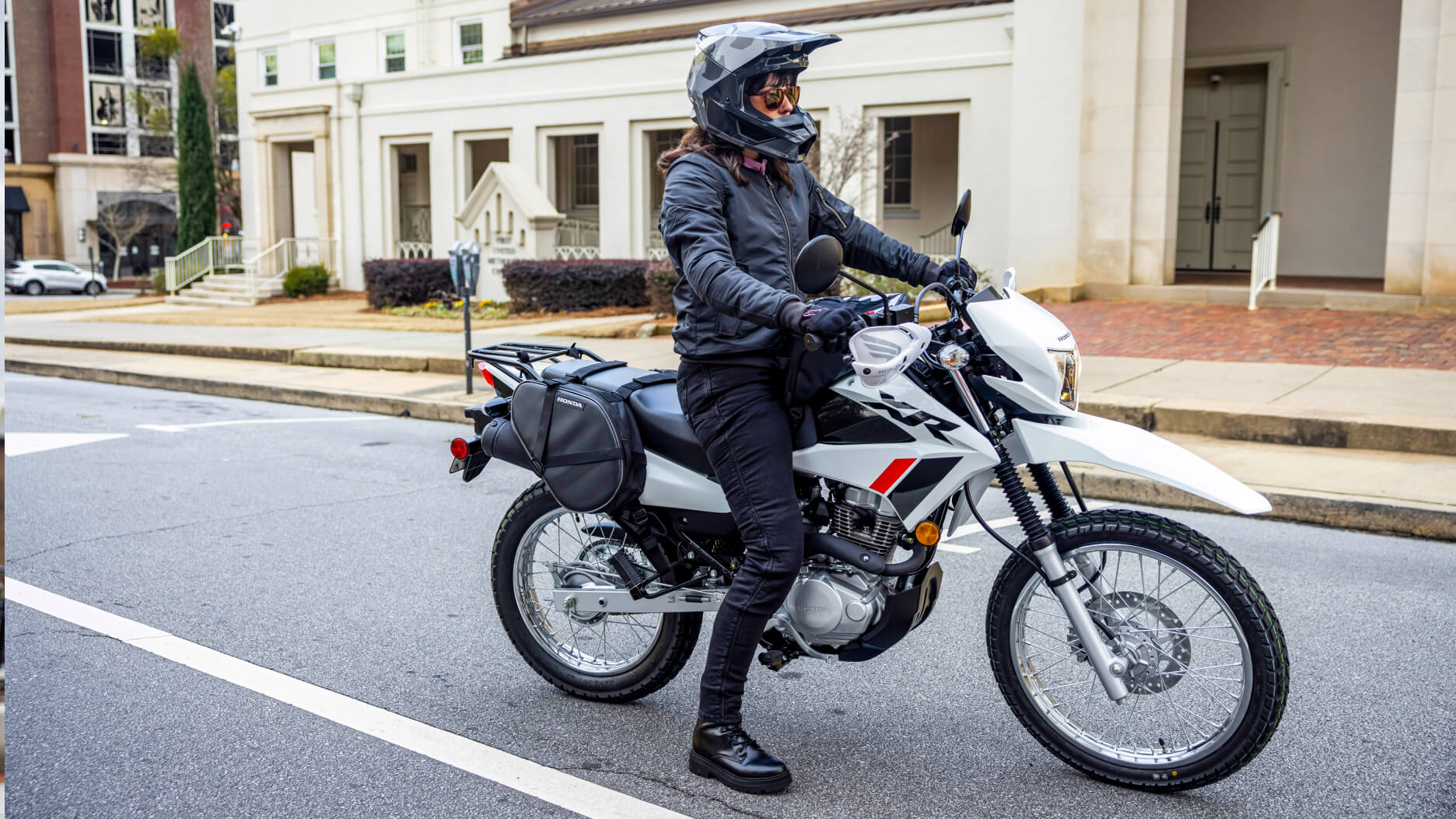 A rider taking off on a Honda XR150L