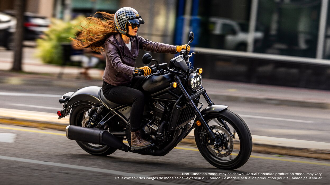 Rider on road going right. Building and sidewalk in background. Non-Canadian model(s) may be shown.  Actual Canadian production model(s) may vary.