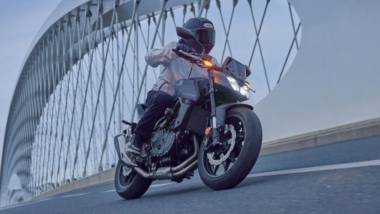 Rider on Bike. Bridge in background.