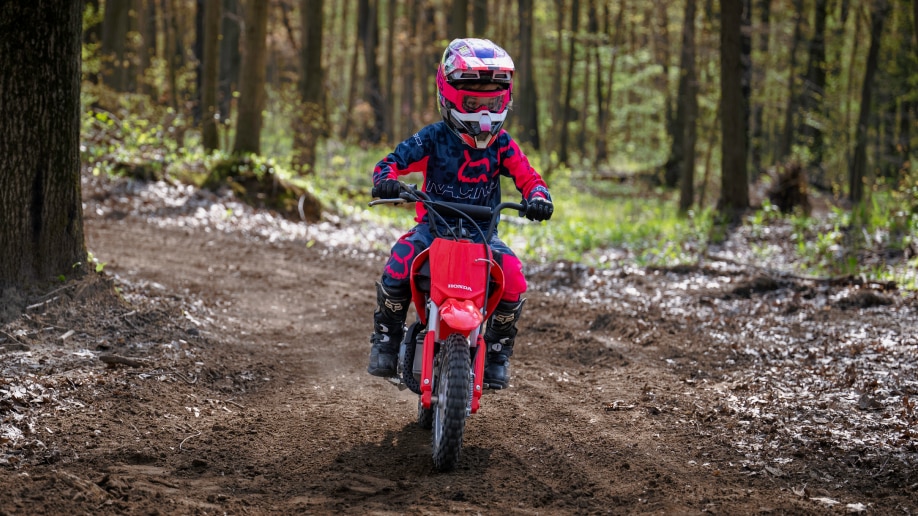 Young rider on dirt track. Front facing.