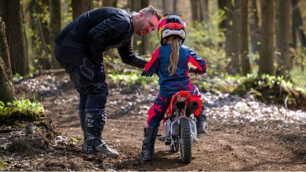 Rear view of back of young rider on bike.