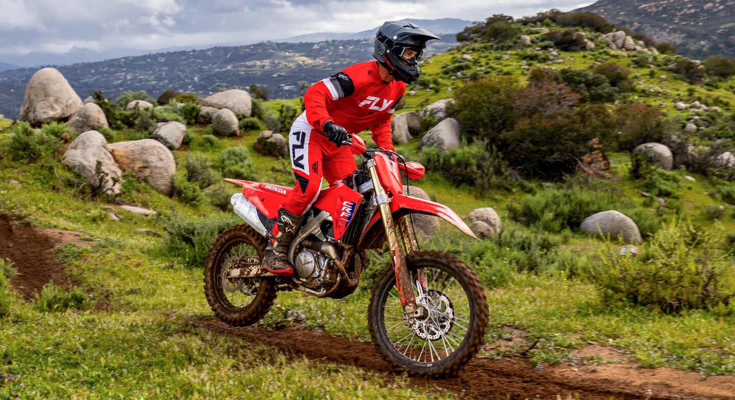 A rider on a CRF450RX on a trail