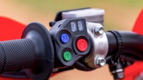 The engine mode select buttons on the handlebars of a Honda CRF450RX