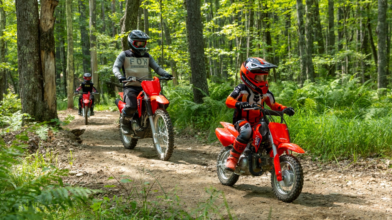 Two riders navigating a flat, open dirt area.