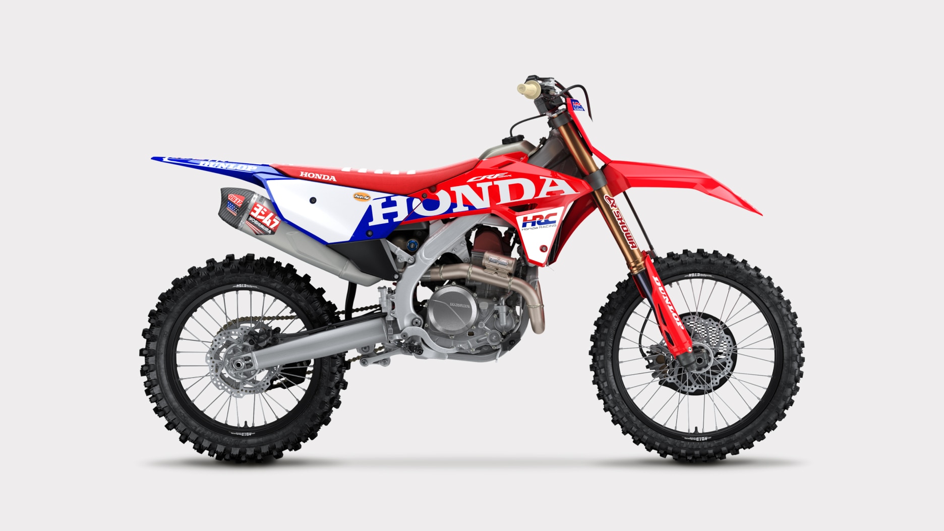 Side profile view of a red and black dirt bike.