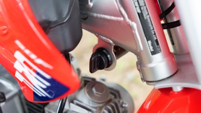 Close-up of the keyed ignition switch located on the side of the motorcycle.
