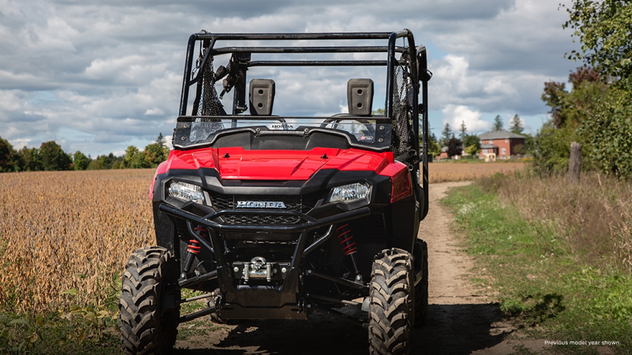 A rider in a Honda Pioneer on a trail  