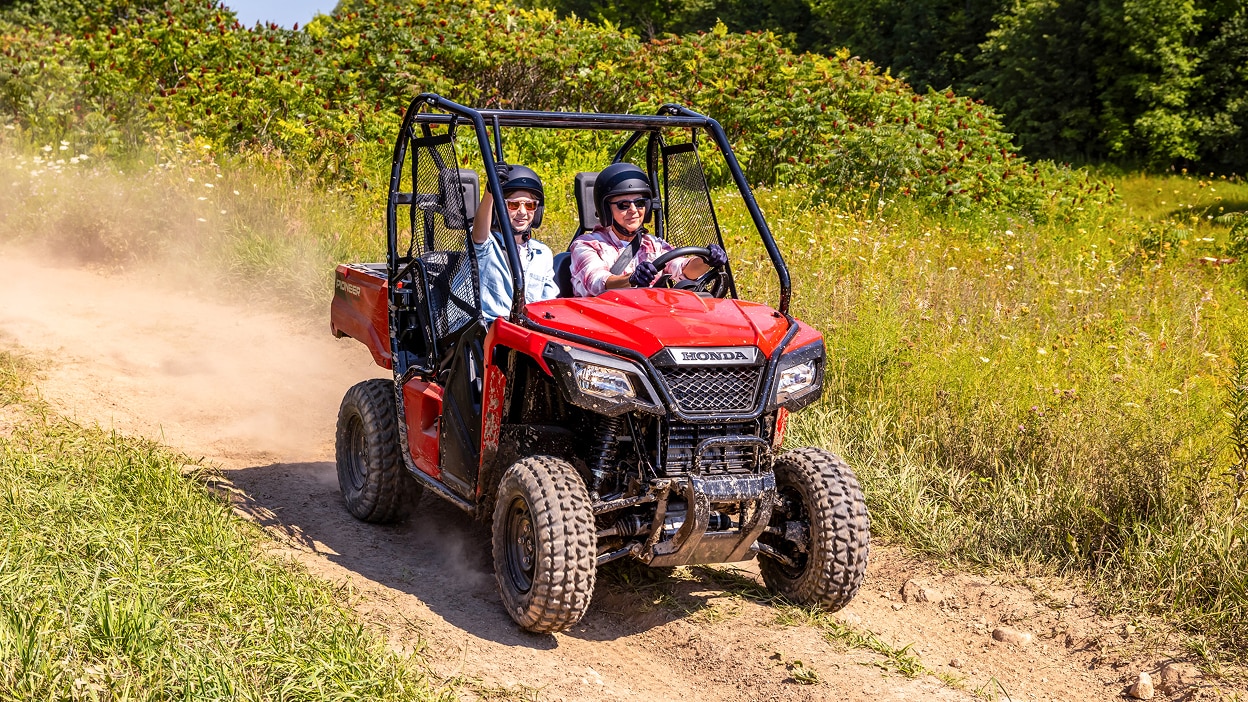 A Honda Pioneer 520 on a dirt path.
