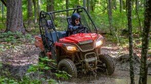 A Honda Pioneer 520 being driven on a trail.