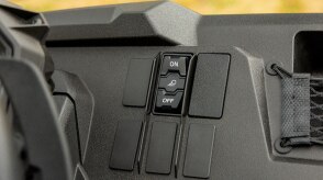 Close-up of blank accessory switches on a vehicle dashboard.