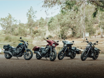 A lineup of Honda motorcycles parked on a road